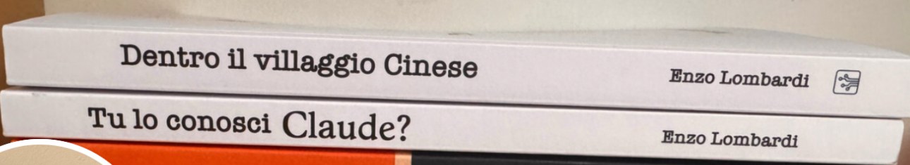 Three paperbacks by Enzo Lombardi stacked on a desk: Dentro il villaggio Cinese, Tu lo conosci Claude?, and OOP to Rust